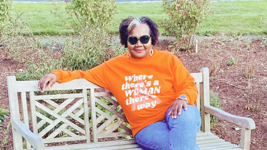 Woman wearing NASTÉ Apparel's Where there's a woman there's a way sweatshirt in orange color